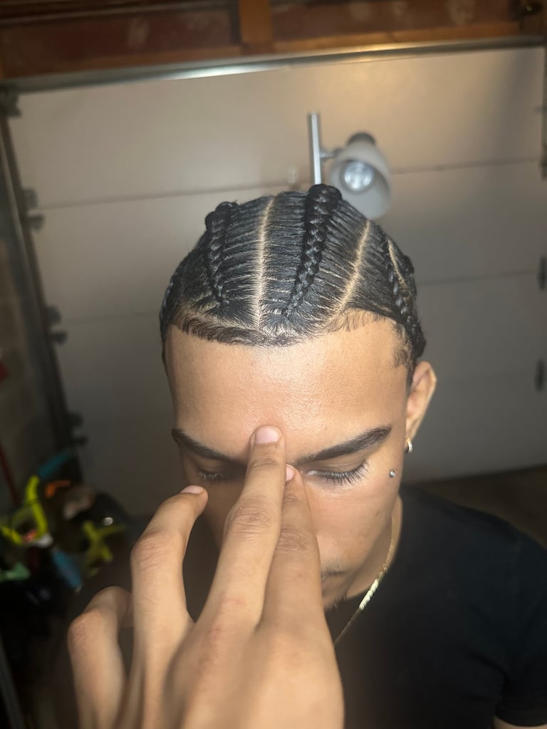 Person displaying braided hairstyle with geometric patterns on head